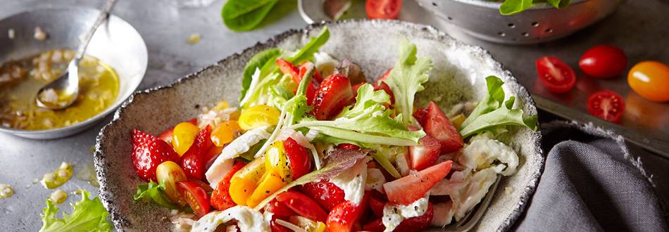 Colourful tomato salad with strawberries